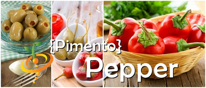 Red heart-shaped sweet pimento peppers in a basket, stuffed green olives, and fresh pimentos on a wooden surface